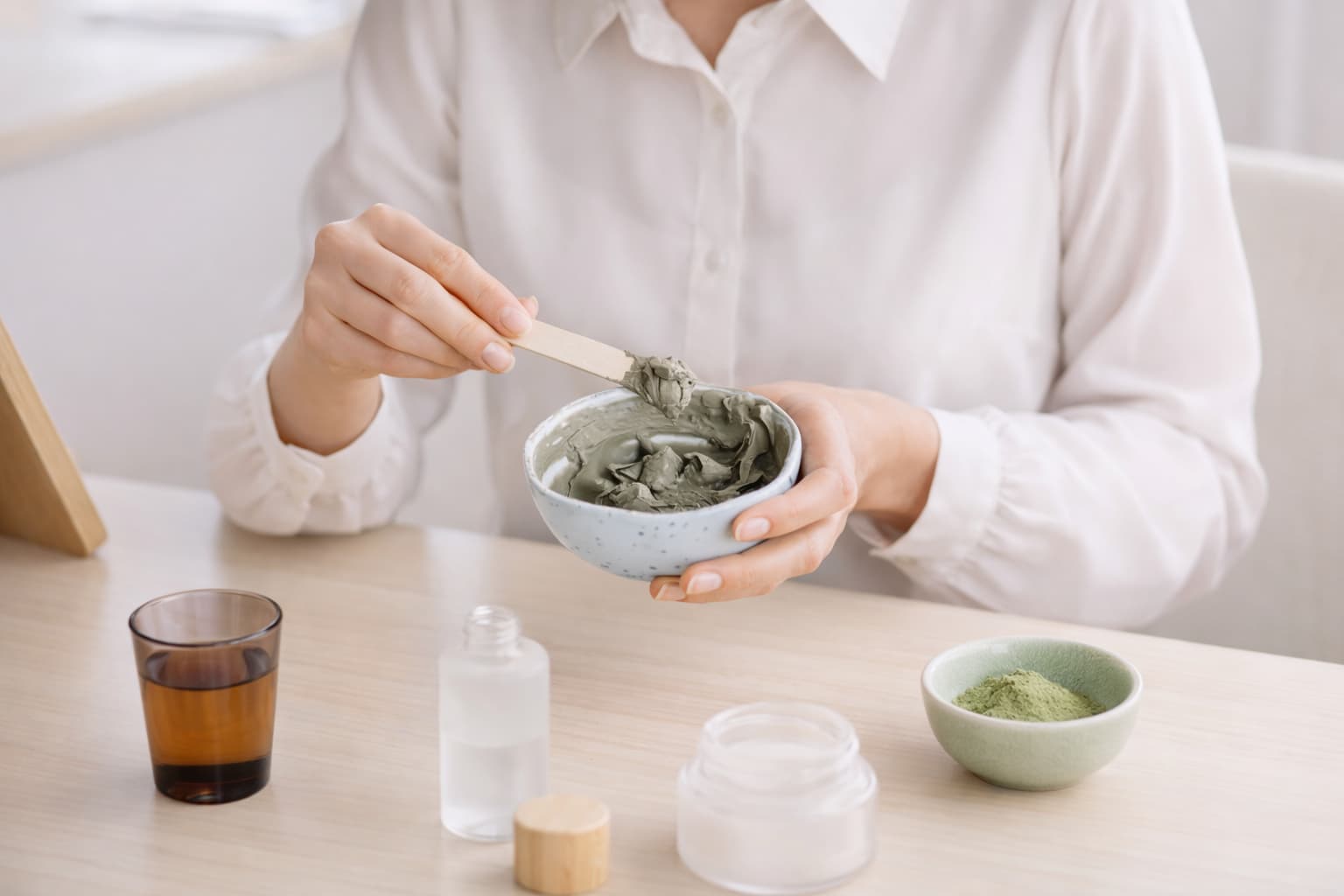 A woman stirs handmade cosmetics in a bowl – making and selling homemade cosmetics