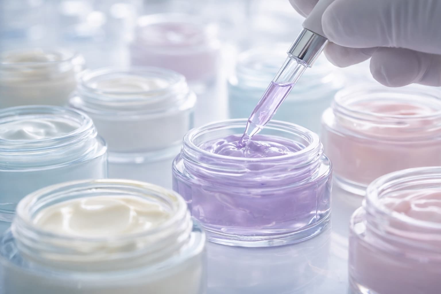 Formulation management for cosmetics — cosmetic formulations in cream jars with a pipette in the laboratory